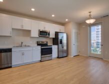 Studio apartment interior at C+C Flats in Chula Vista, CA — open living area with modern finishes