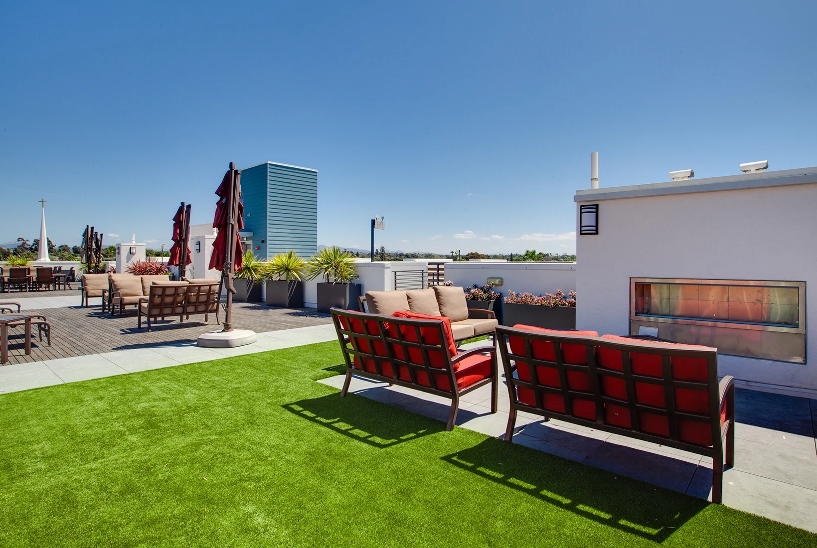 Outdoor fireplace lounge on rooftop at C+C Flats luxury apartments in Chula Vista CA