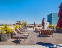 Outdoor BBQ picnic area on rooftop at C+C Flats apartment community Chula Vista